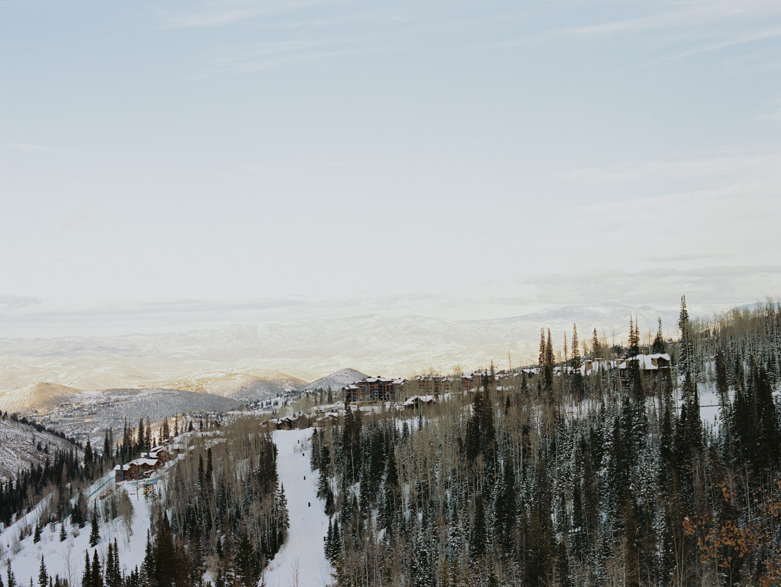Another scenic view of the snowy mountains at Montage Deer Valley. The skies were blue and the snow was pure white. There are tall trees everywhere. A dream Park City winter wedding venue.