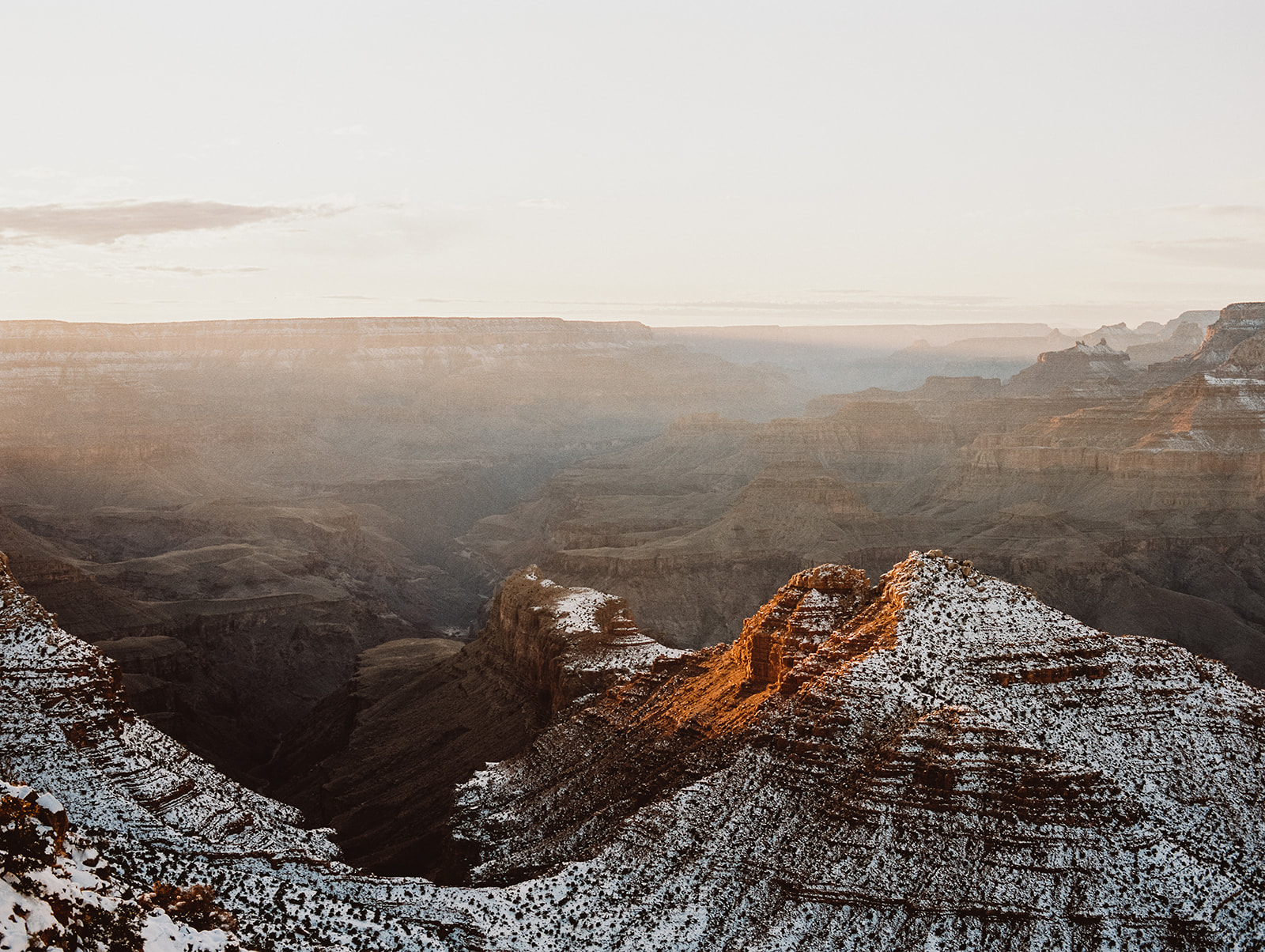 A scenic view of the Grand Canyon covered in snow