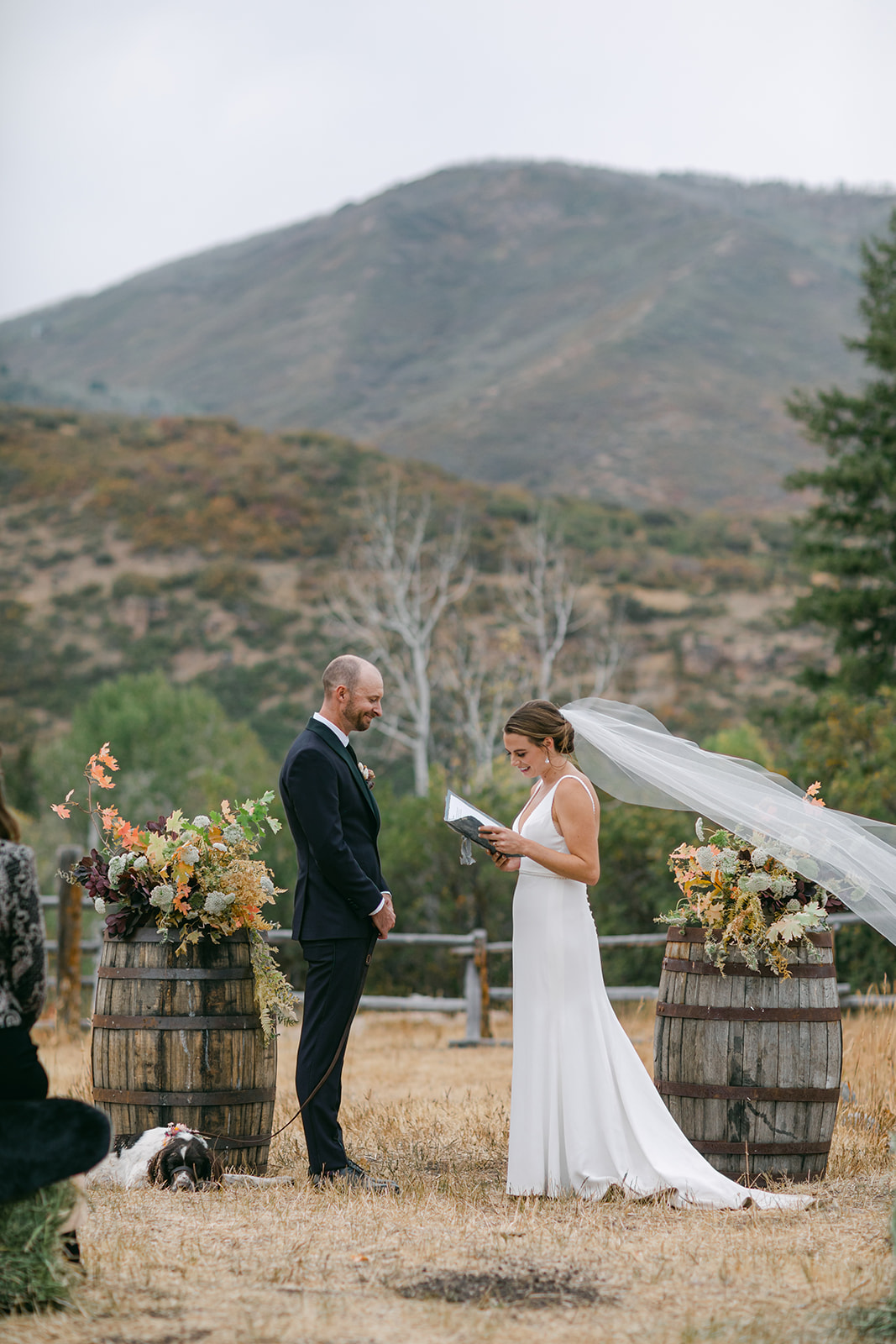 a rustic modern wedding in the high mountains of Utah. The bride is a caucasian female wearing a white crepe fabric wedding dress.