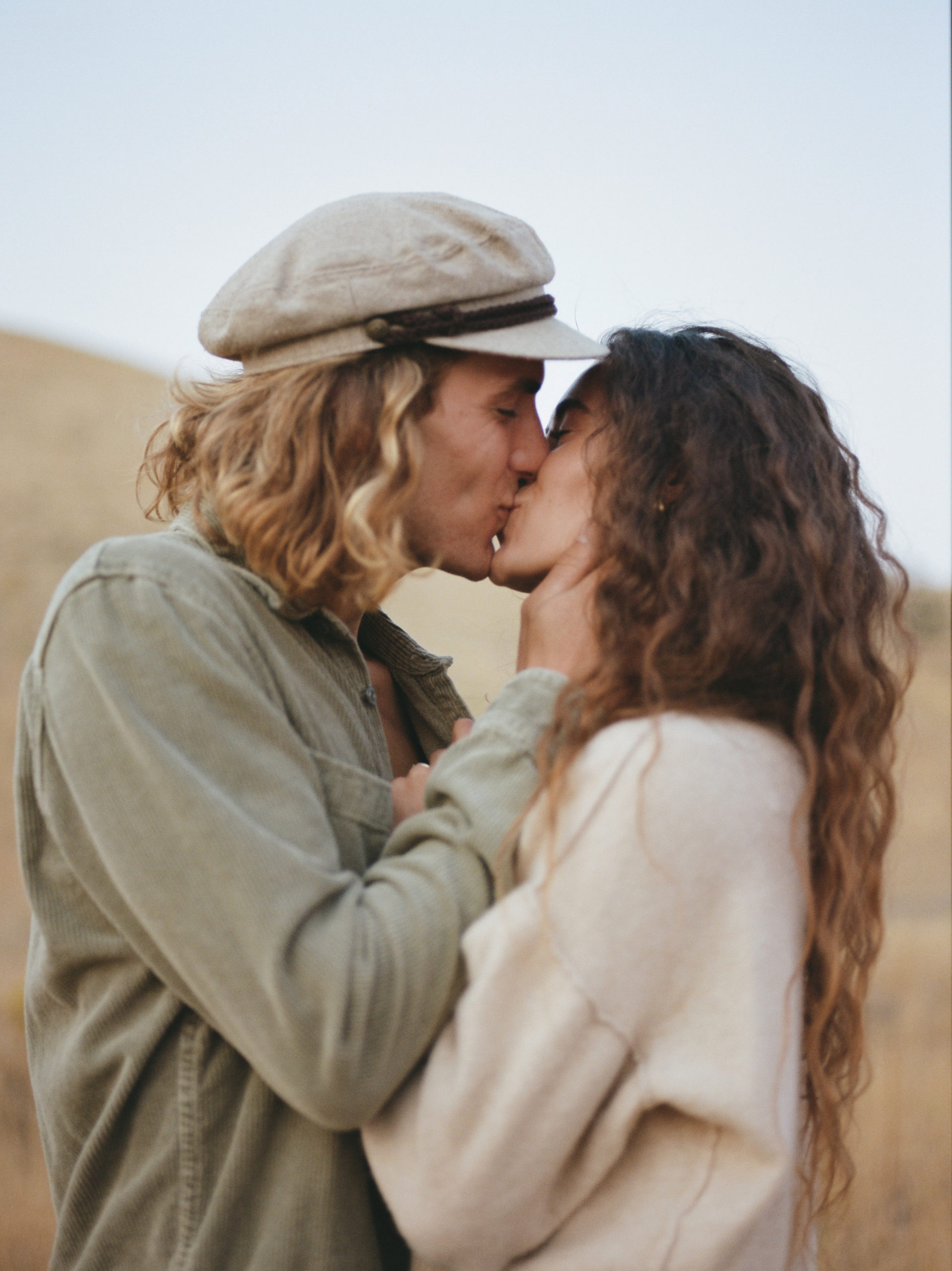 A female with brunette long hair and a male with short blonde hair couple posing for their engagement photos in their Utah location.