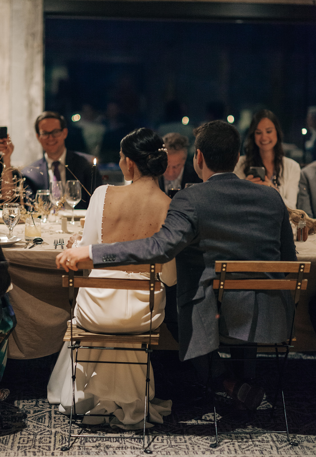 bride and groom enjoying dinner with their guests at their intimate wedding reception