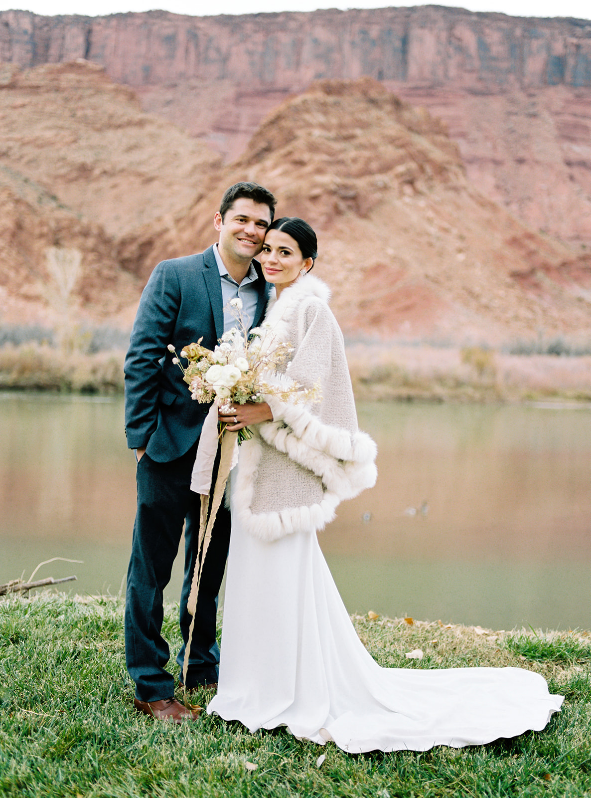 bride and groom pose at their destination wedding in moab utah