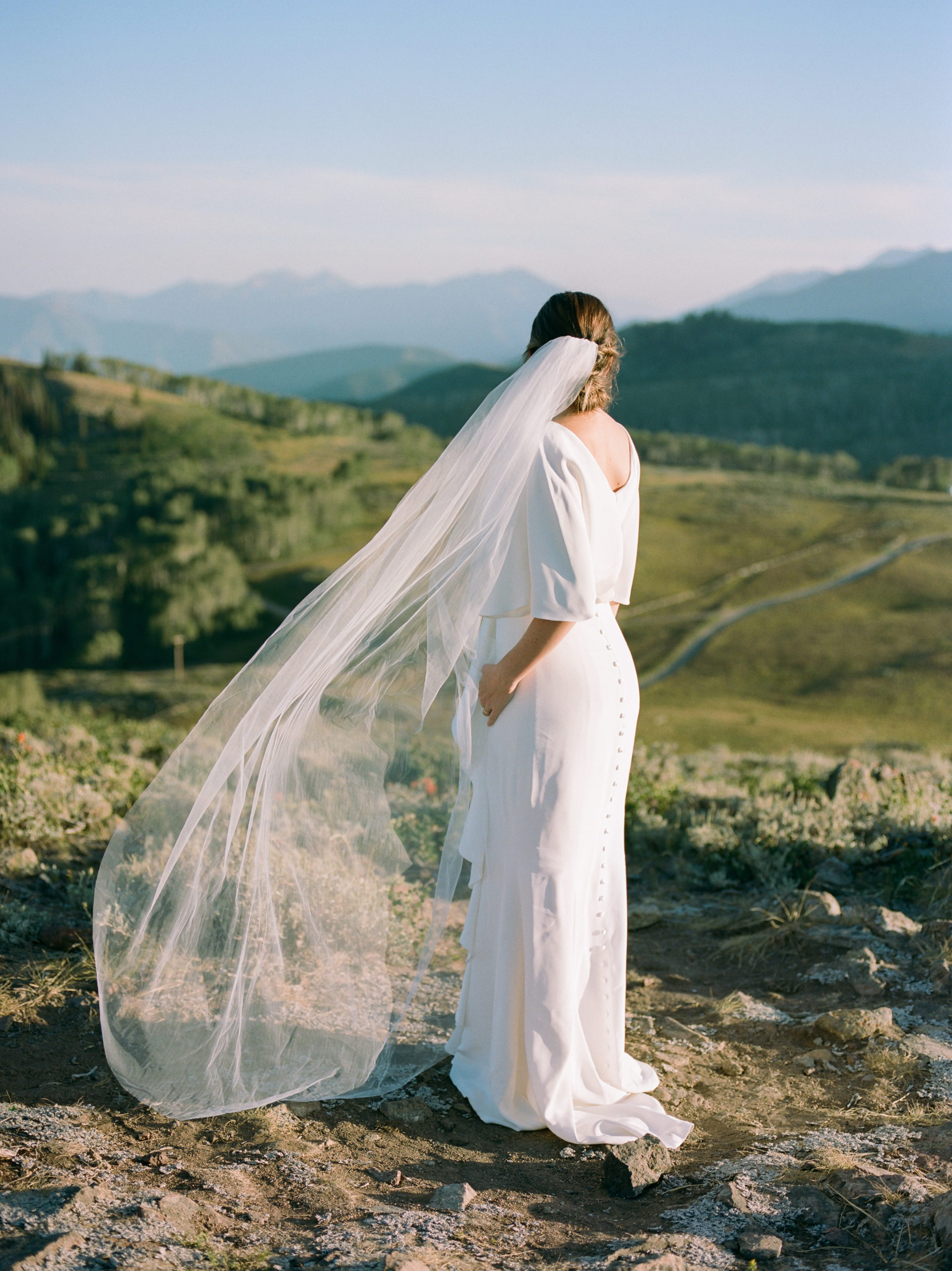 bride poses for formal portraits in her veil 