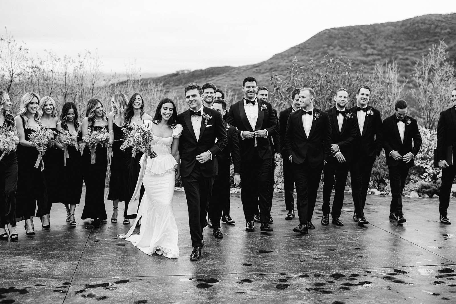 outdoor bridal party photos at a vintage inspired blue sky ranch wedding in utah. black mismatched bridesmaids dresses and black groomsmen tuxedos. photo by megan robinson photography