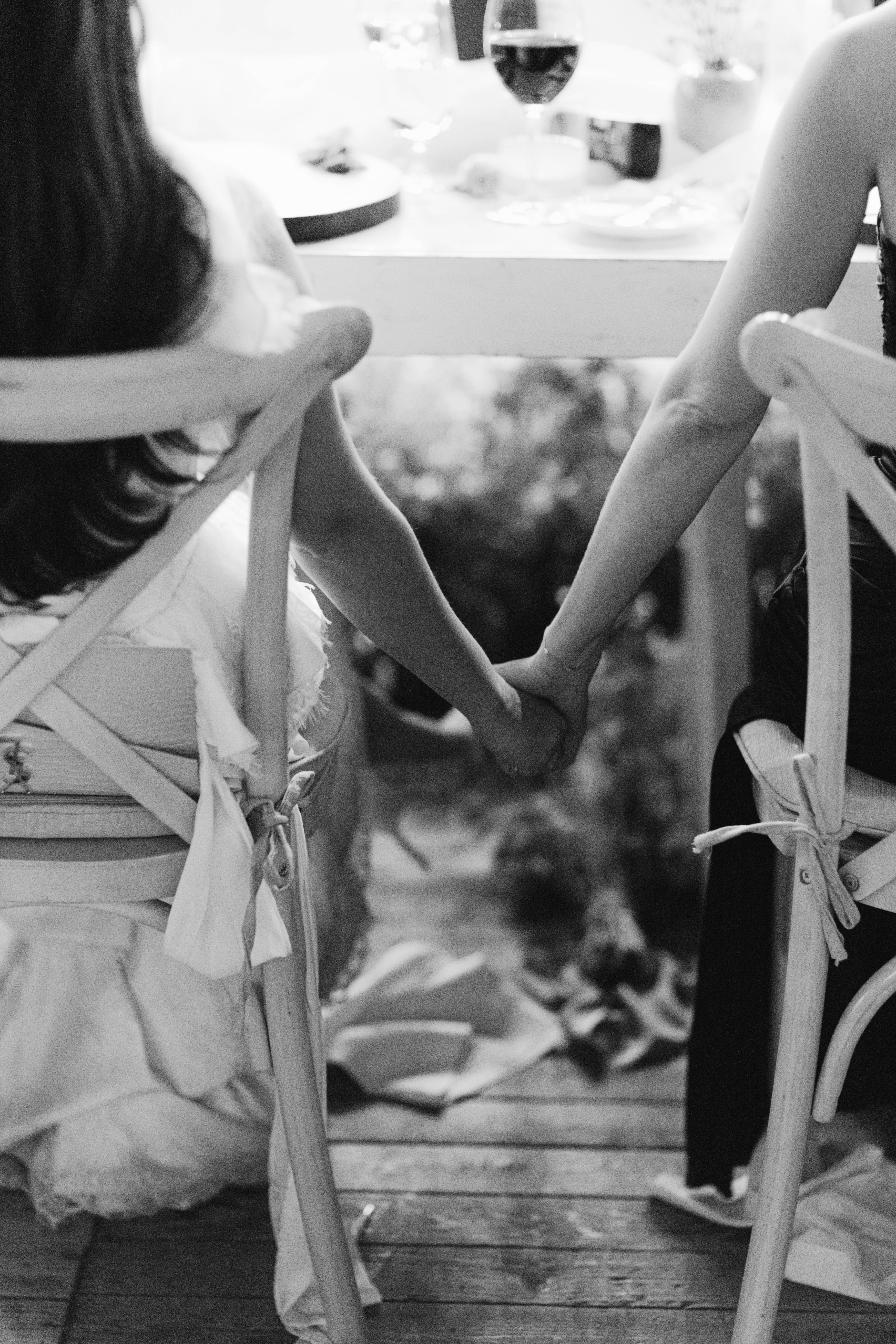 bride and maid of honor holding hands at a utah ranch wedding. photo taken by megan robinson photography
