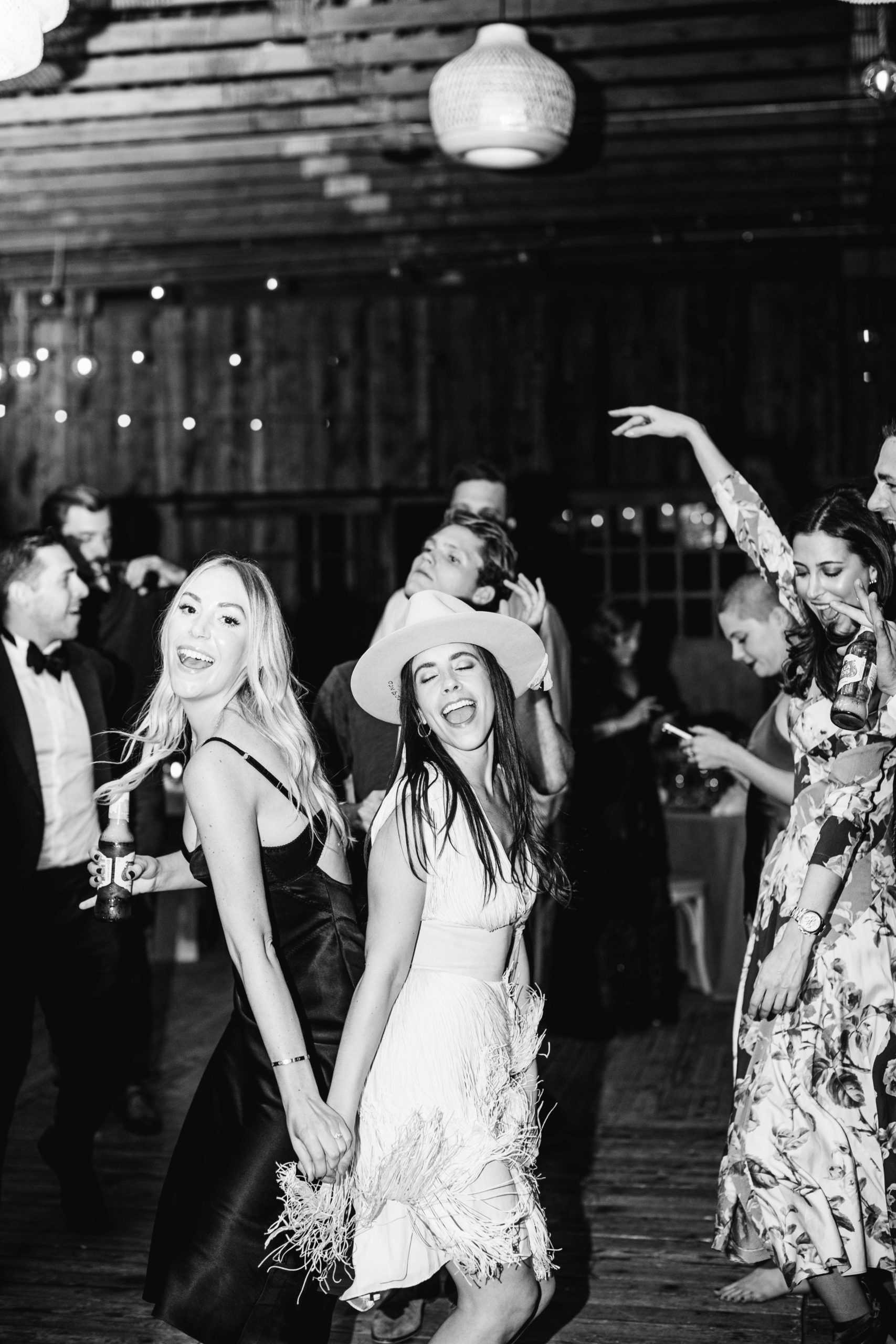 a bride and her guests dance at a wedding reception at blue sky ranch in utah. photo by megan robinson photography
