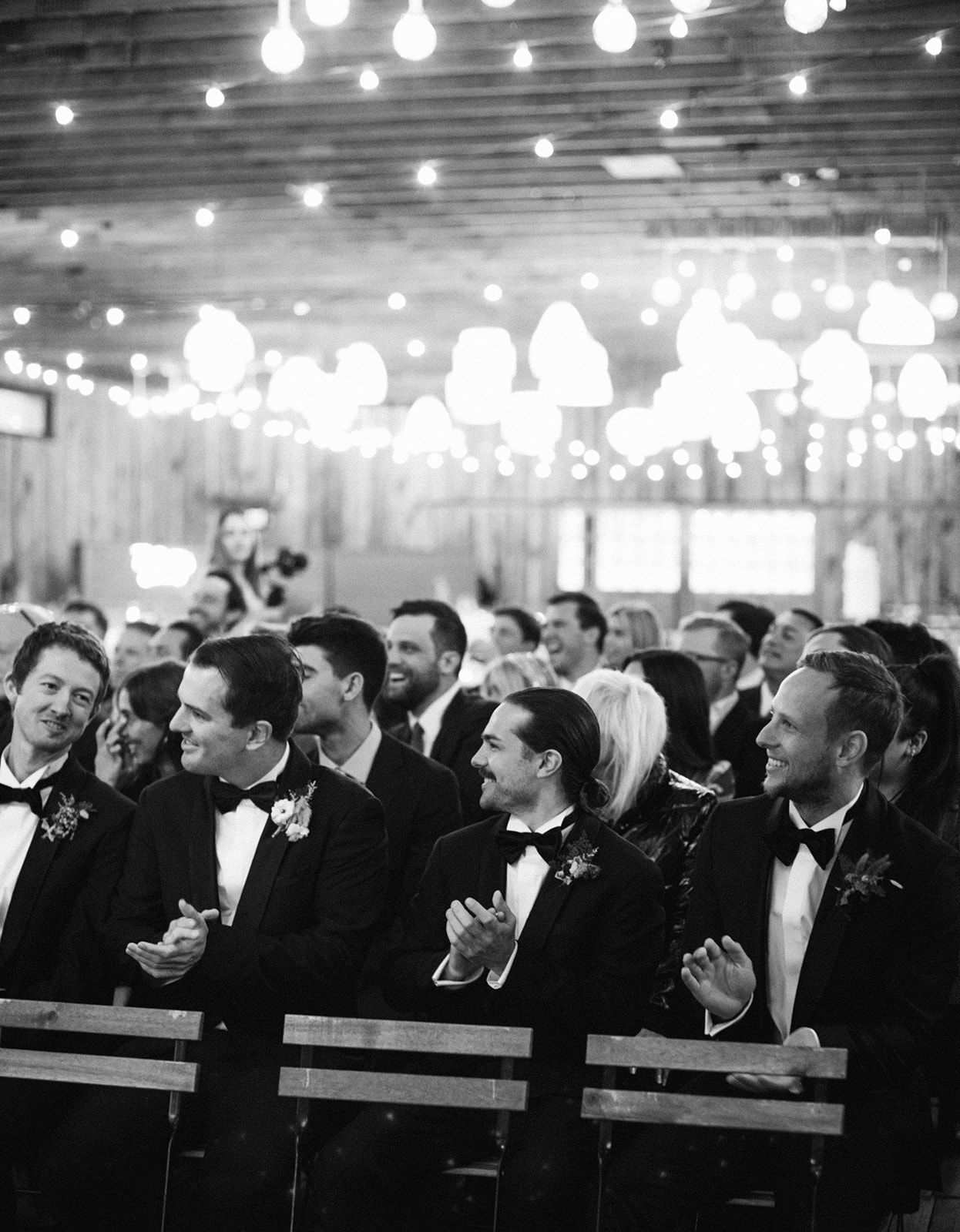 groomsmen watching a wedding ceremony at a blue sky ranch wedding in utah. photo taken by megan robinson photography