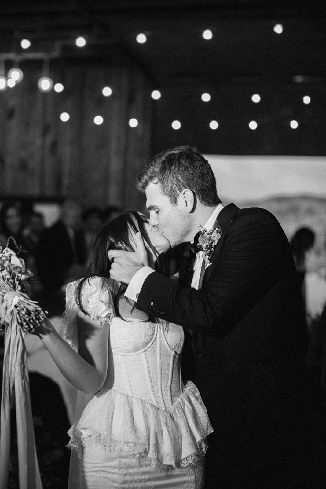 the bride and groom kiss as they walk down the aisle together at their blue sky ranch destination wedding in utah. photo taken by megan robinson photography