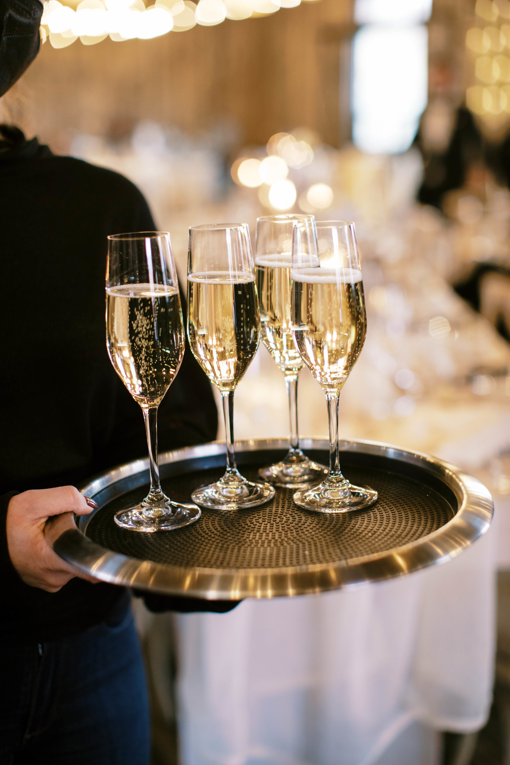 a tray of champagne being served at a blue sky ranch wedding in utah. photo by megan robinson photography