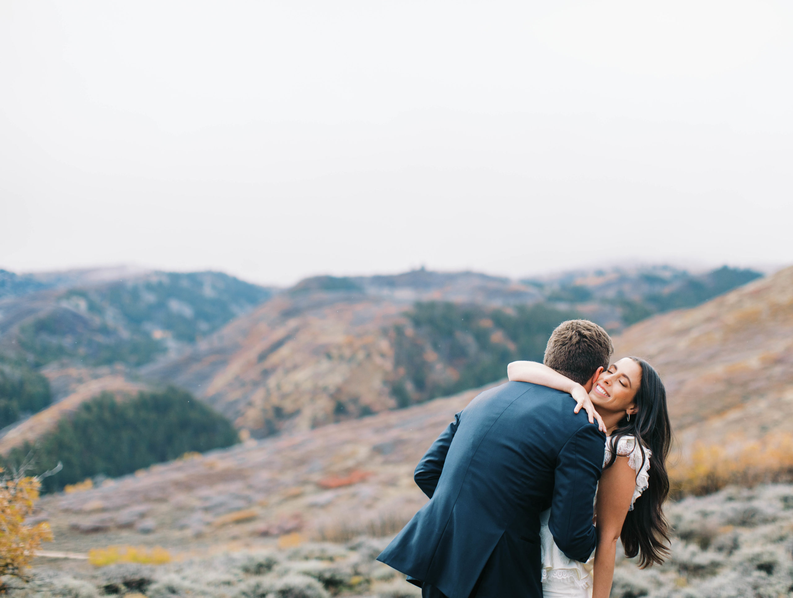 a bride and groom hug during their wedding day first look at blue sky ranch in utah. photo taken by megan robinson photography