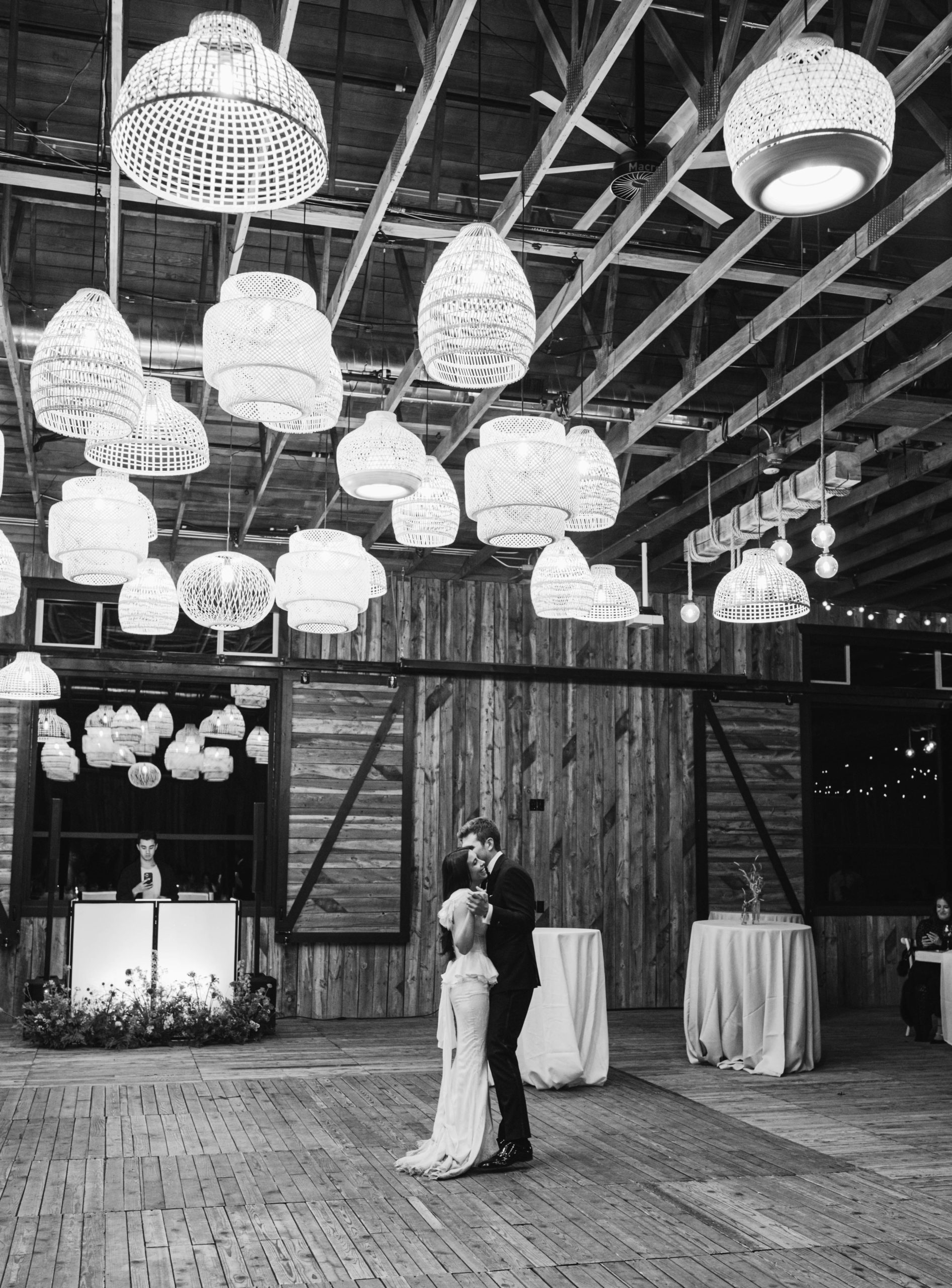 a couple dances at their blue sky ranch wedding in park city utah under glowing lights