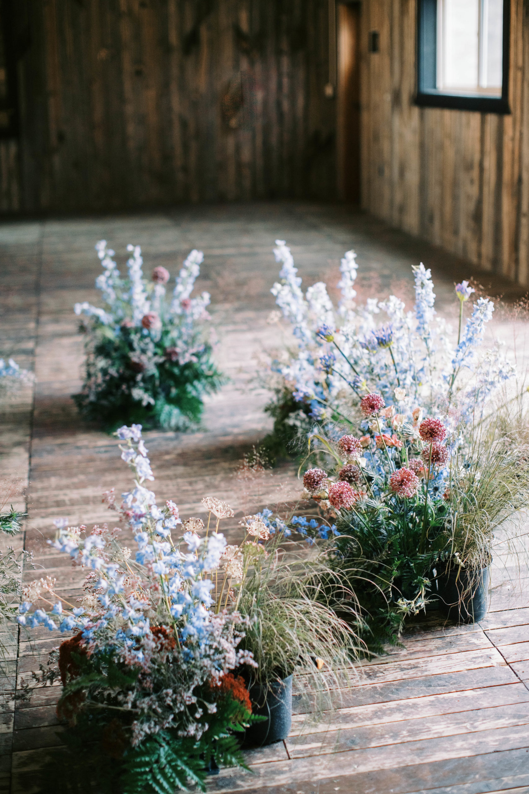 wildflower wedding ceremony flowers frame the altar at an eclectic blue sky ranch wedding in utah. photo taken by megan robinson photography