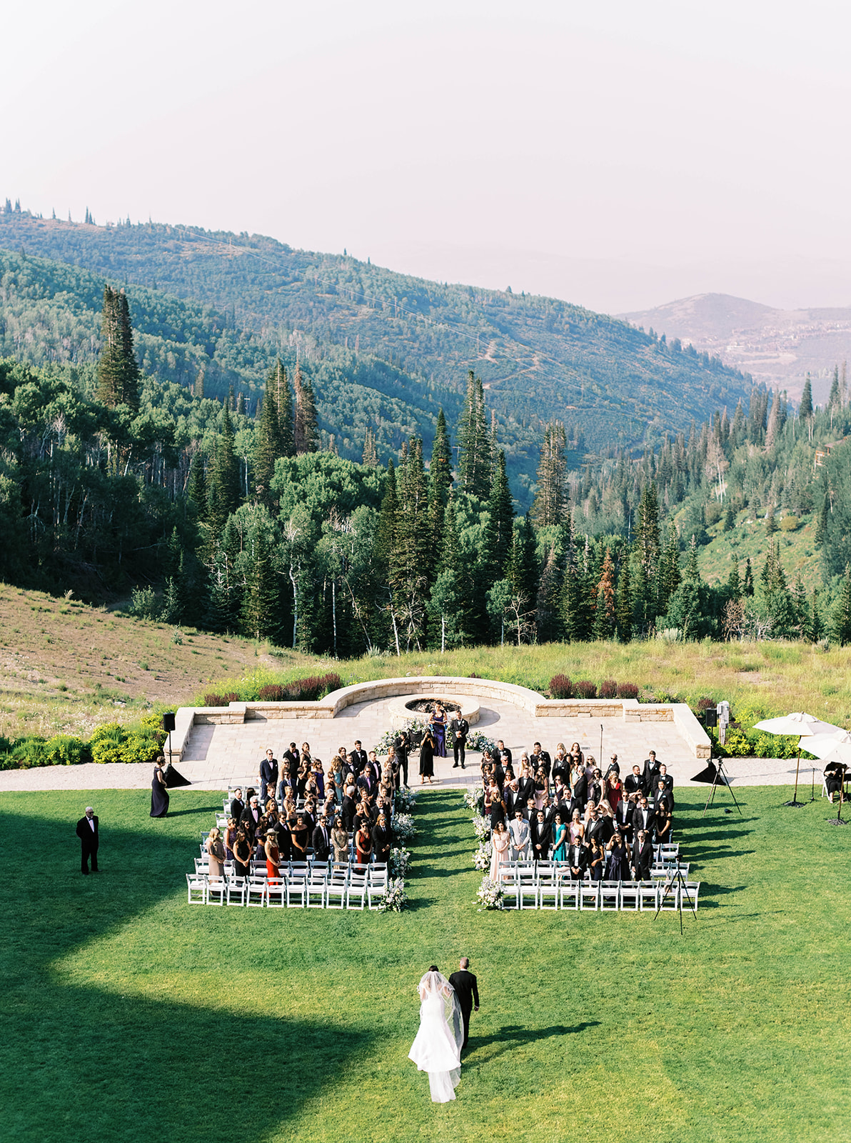a bride walks towards her groom at this mountain wedding at montage deer valley resort in park city utah. photo by megan robinson photography