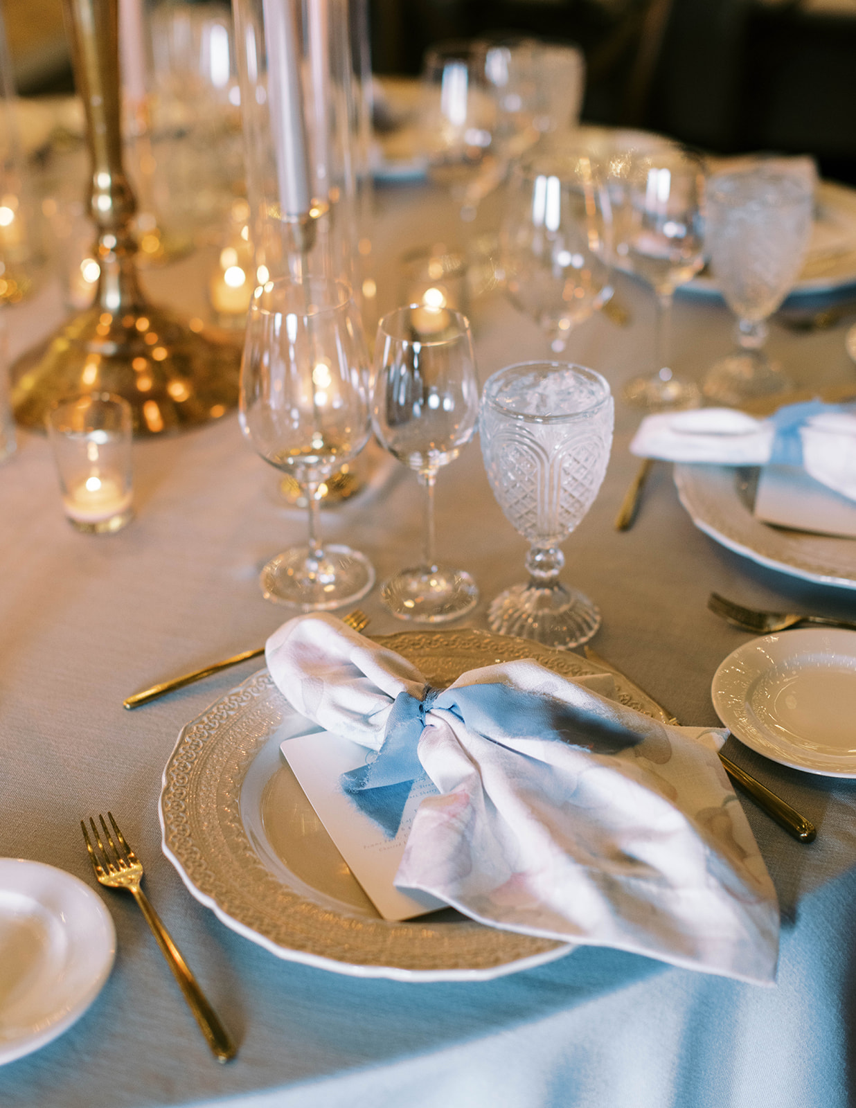 place setting with blue tablecloths for a garden theme wedding at montage deer valley resort in park city utah. photo by megan robinson photography