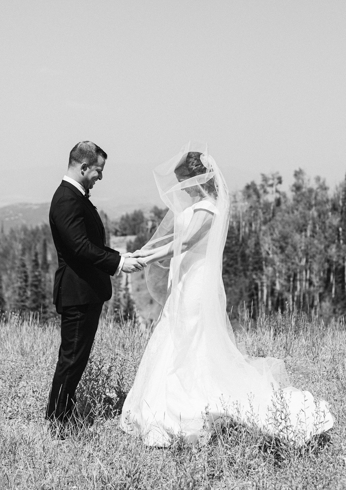 bride and groom look at each other during their first look during this mountain garden themed wedding at montage deer valley in utah. photo taken by megan robinson photography