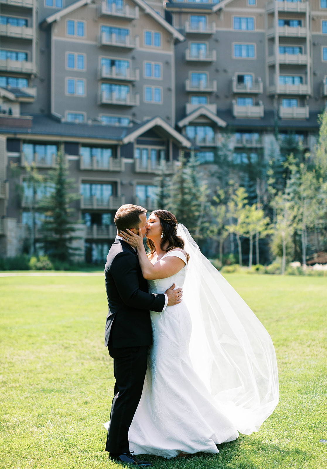 bride and groom kiss at their mountain garden themed wedding at montage deer valley in utah. photo taken by megan robinson photography