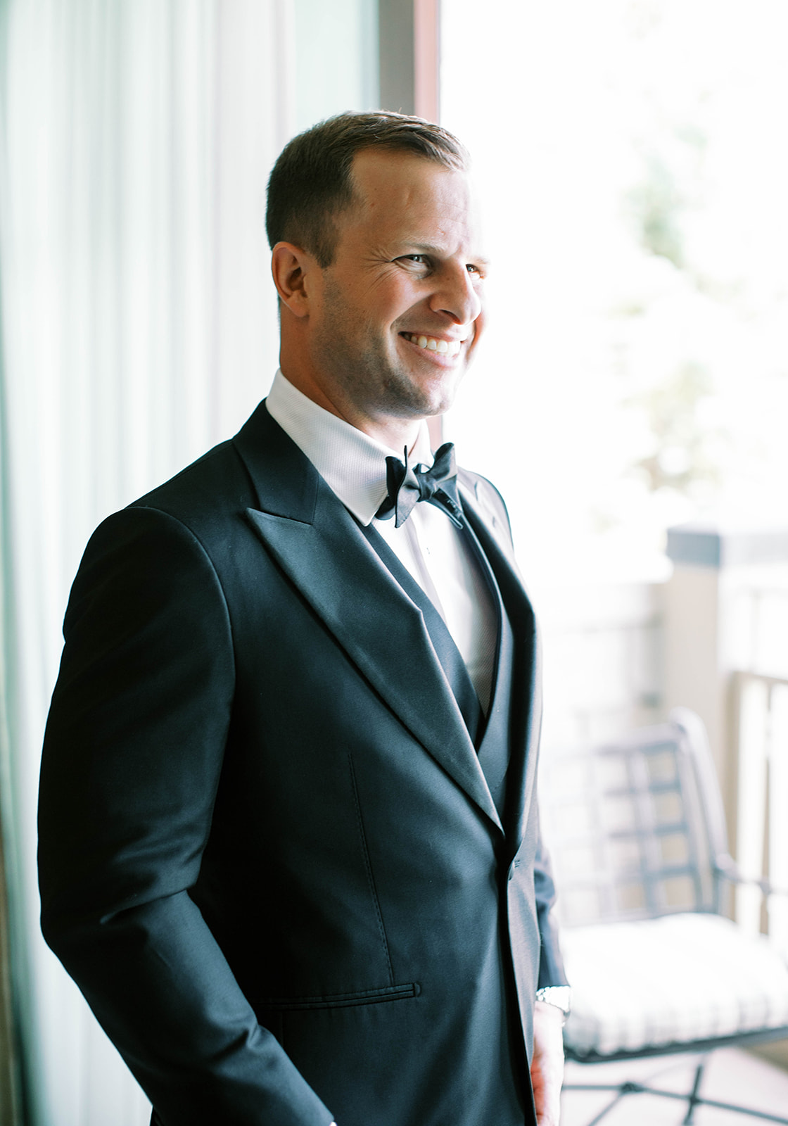 a groom gets dressed for his garden party wedding in park city utah. photo by megan robinson photography