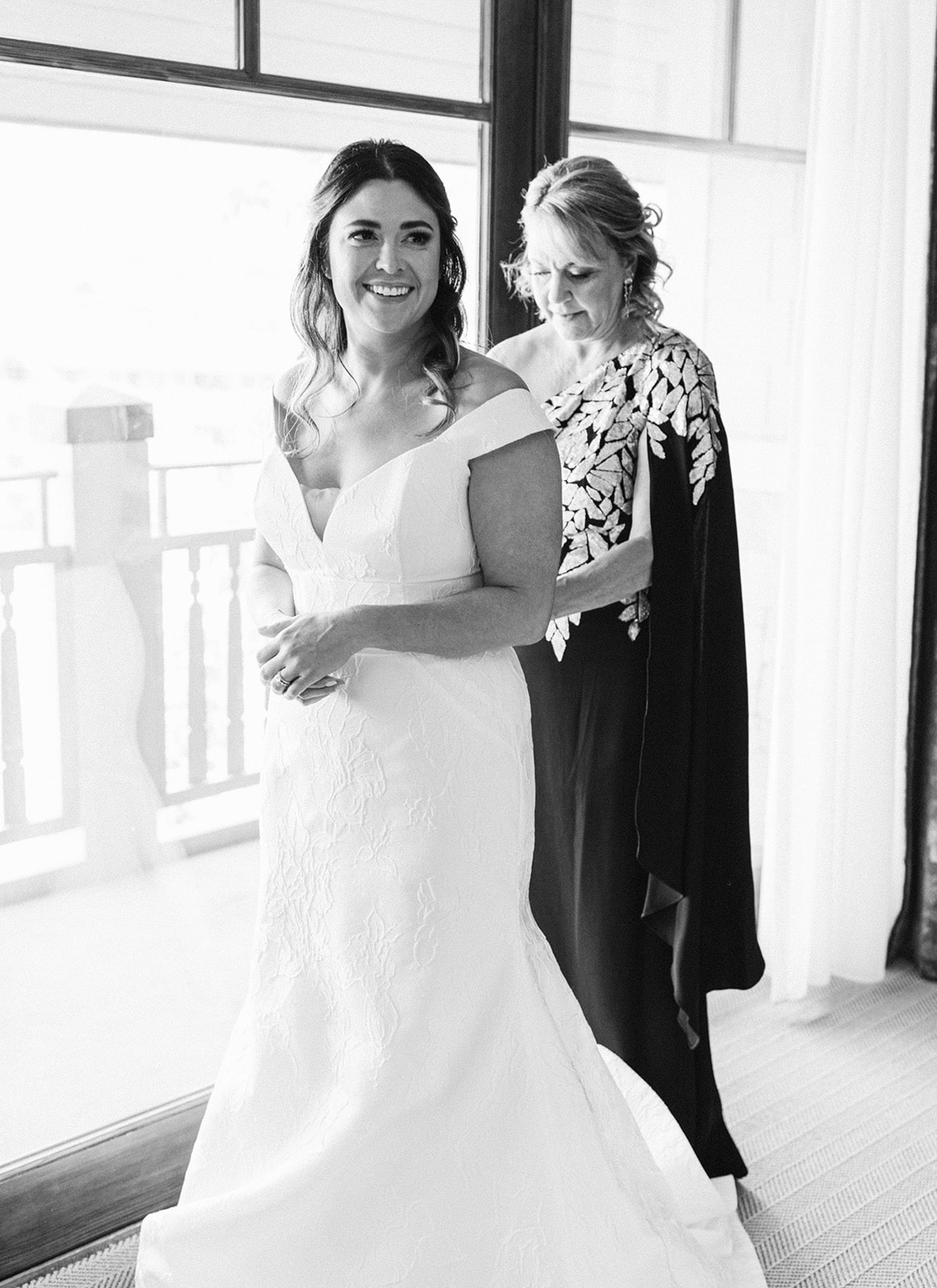 a bride and her mom smile at one another while getting ready during this garden party wedding at montage deer valley resort. photo by megan robinson photography