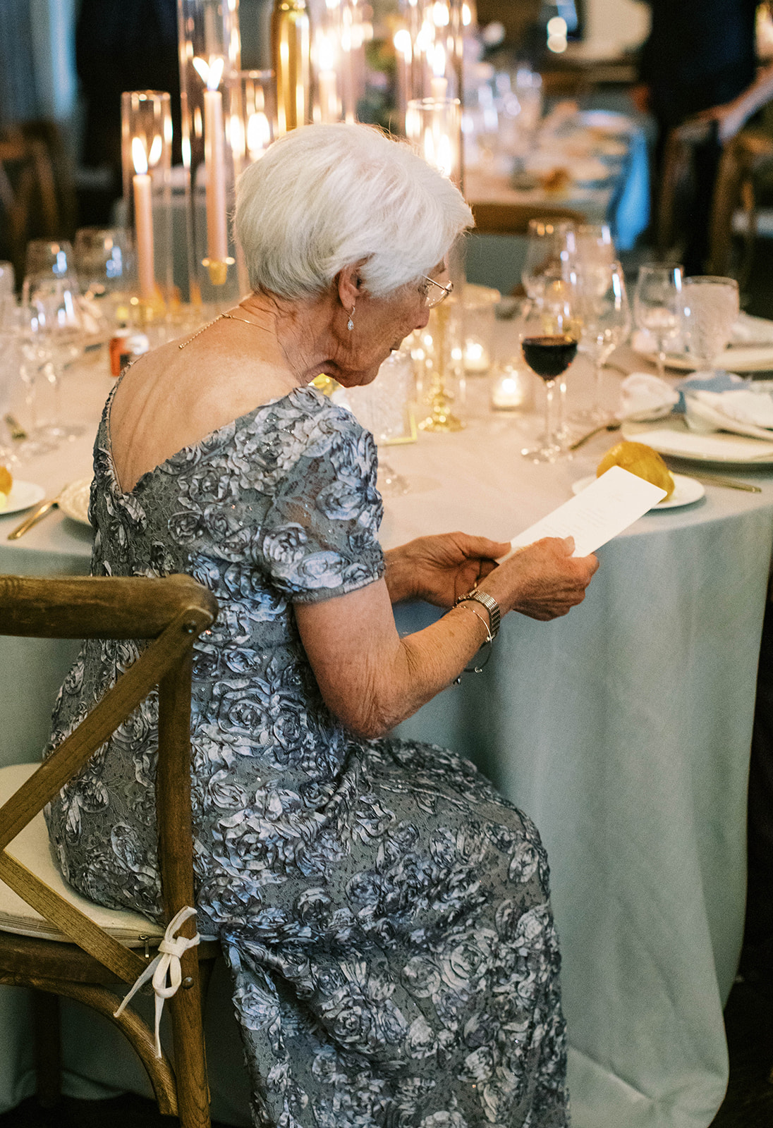 mother of the groom reads the custom wedding menus at this montage deer valley garden theme wedding reception. photo by megan robinson photo