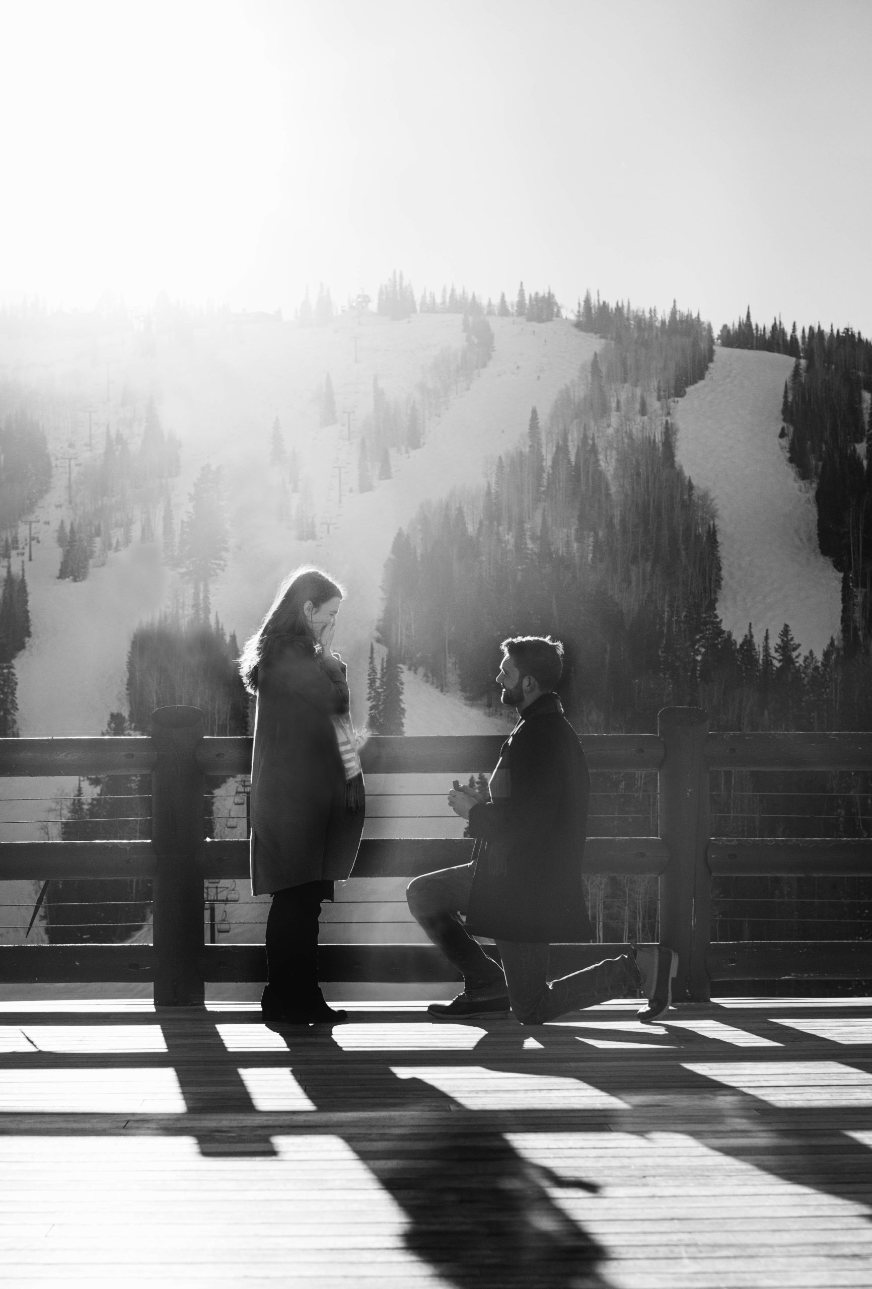 a man gets down on one knee to propose to his girlfriend in park city utah. photo taken by Megan Robinson Photography