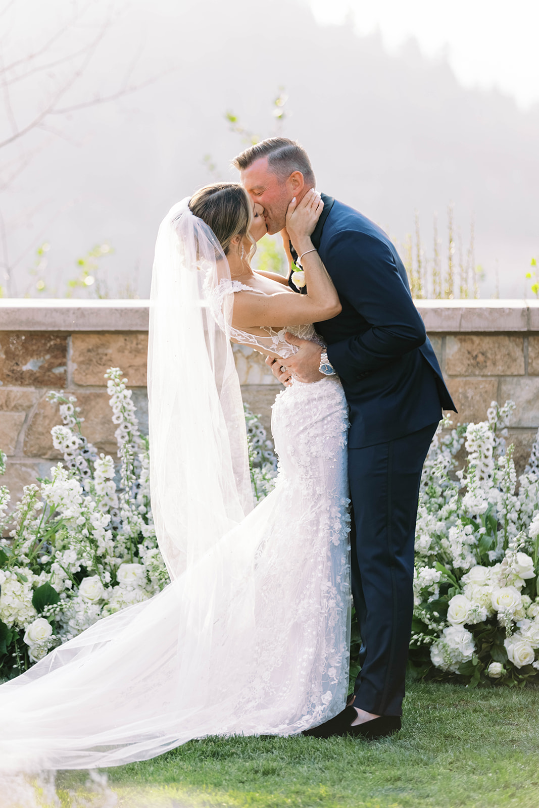 a bride and groom kiss for the first time as husband and wife during their st regis deer valley wedding ceremony 