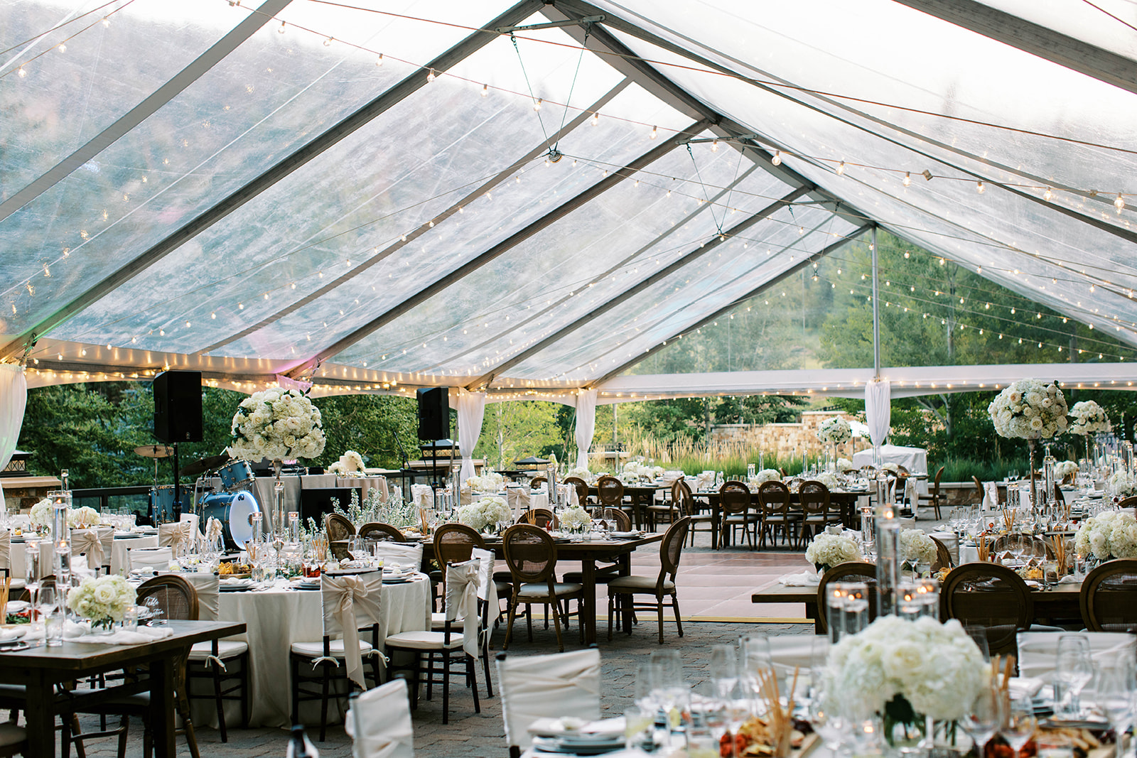 the reception setup for an outdoor wedding at st regis deer valley under a clear top tent 