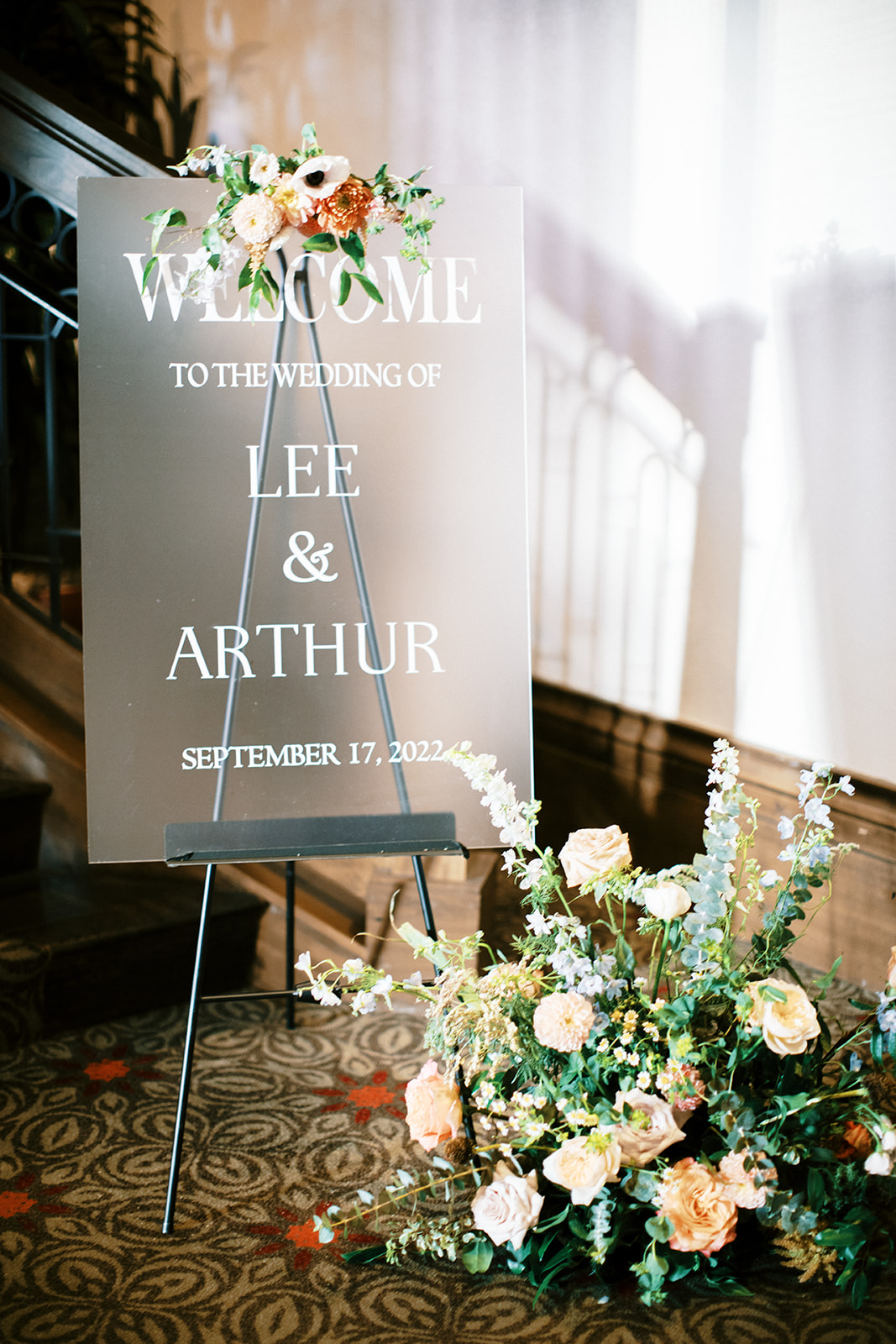 a wedding welcome sign with colorful flowers 