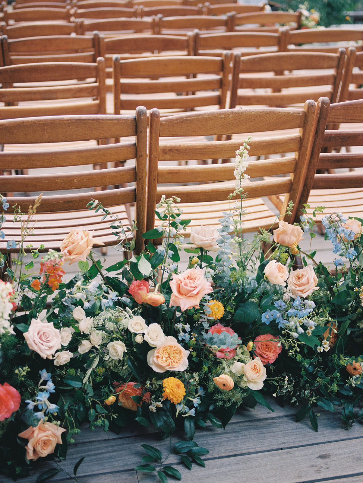 colorful wedding ceremony flowers lining the aisle for a summer wedding at stein eriksen lodge in park city utah