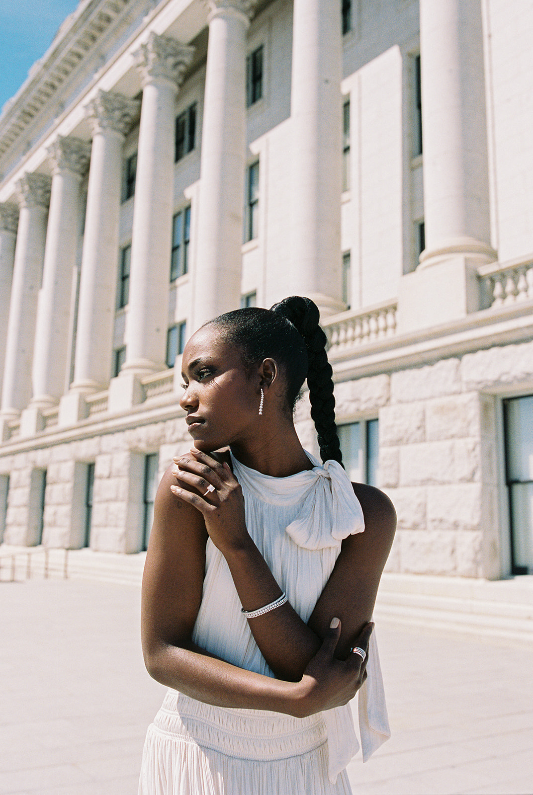 a model poses outside the utah capitol building wearing a modern engagement ring by j brooks jewelers 