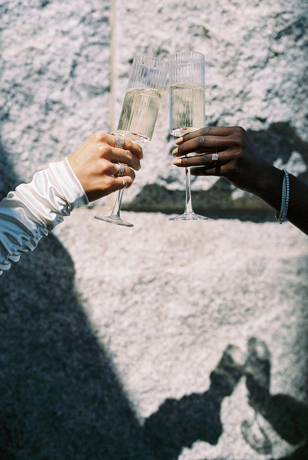 two models cheers with champagne during a jewelry brand photoshoot