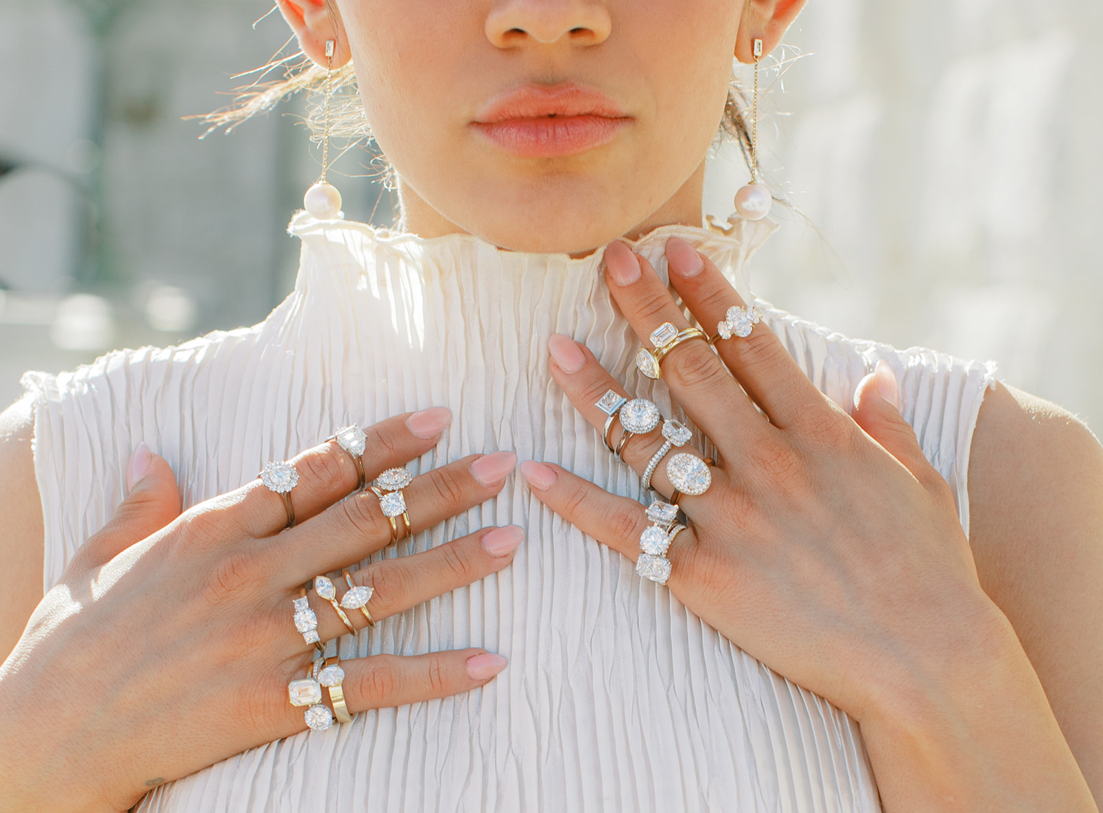a model wears lots of modern engagement rings by j brooks jewelers in utah